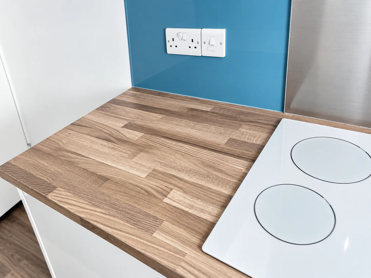 An induction hob and wood worktop left clean after appliance detailing